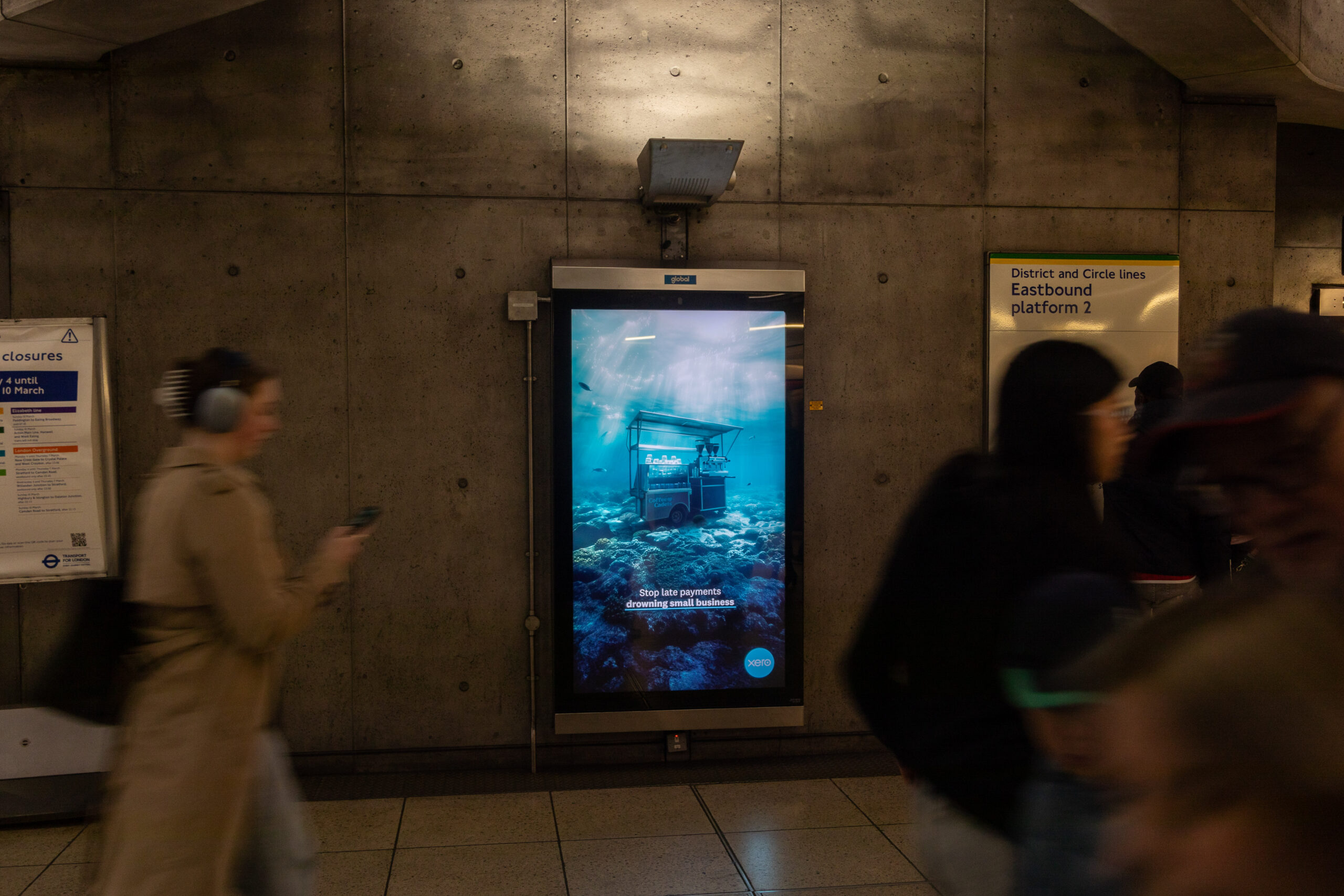 Xero Accounting Software advertising in Westminster Station London, with busy commuters rushing past