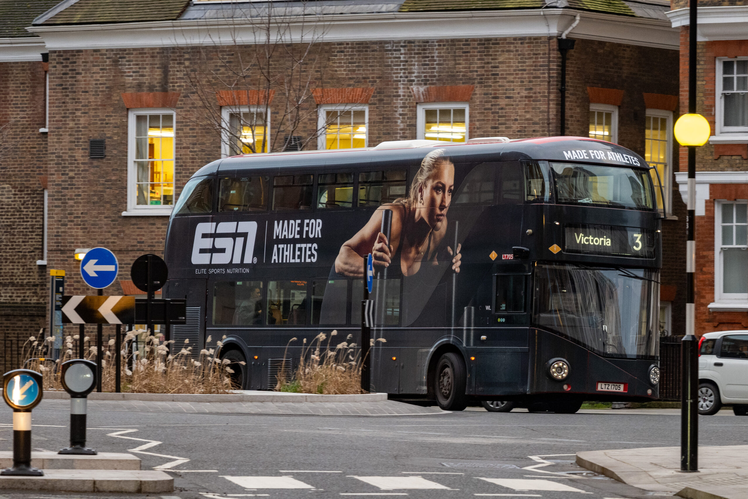 ESN advert on a bus in London, the advert shows a strong woman exercising with the slogan made for athletes