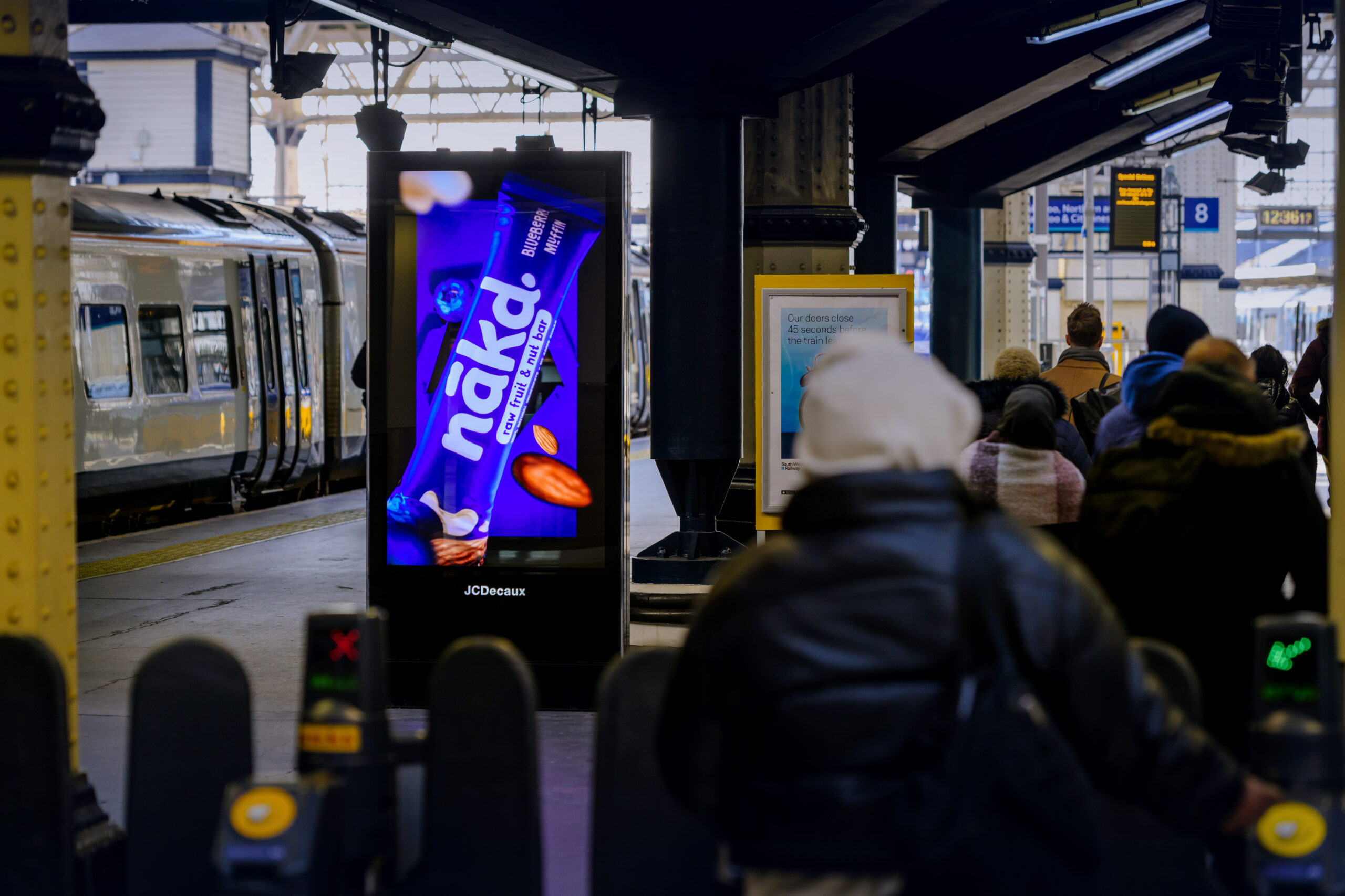 An example of 3D digital billboard advertising within a train station.