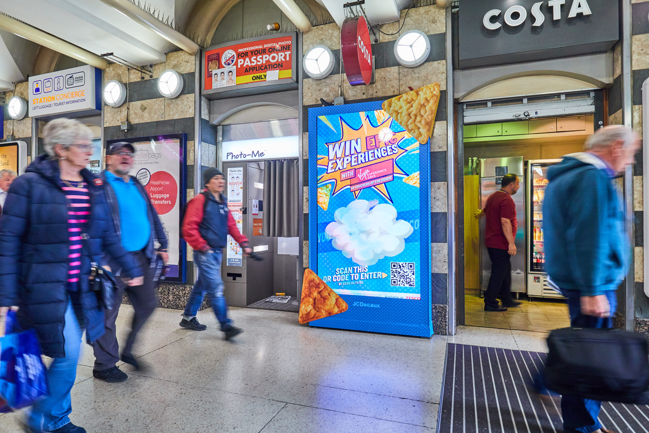 An example of a wrapped digital screen in a train station for pop chips.